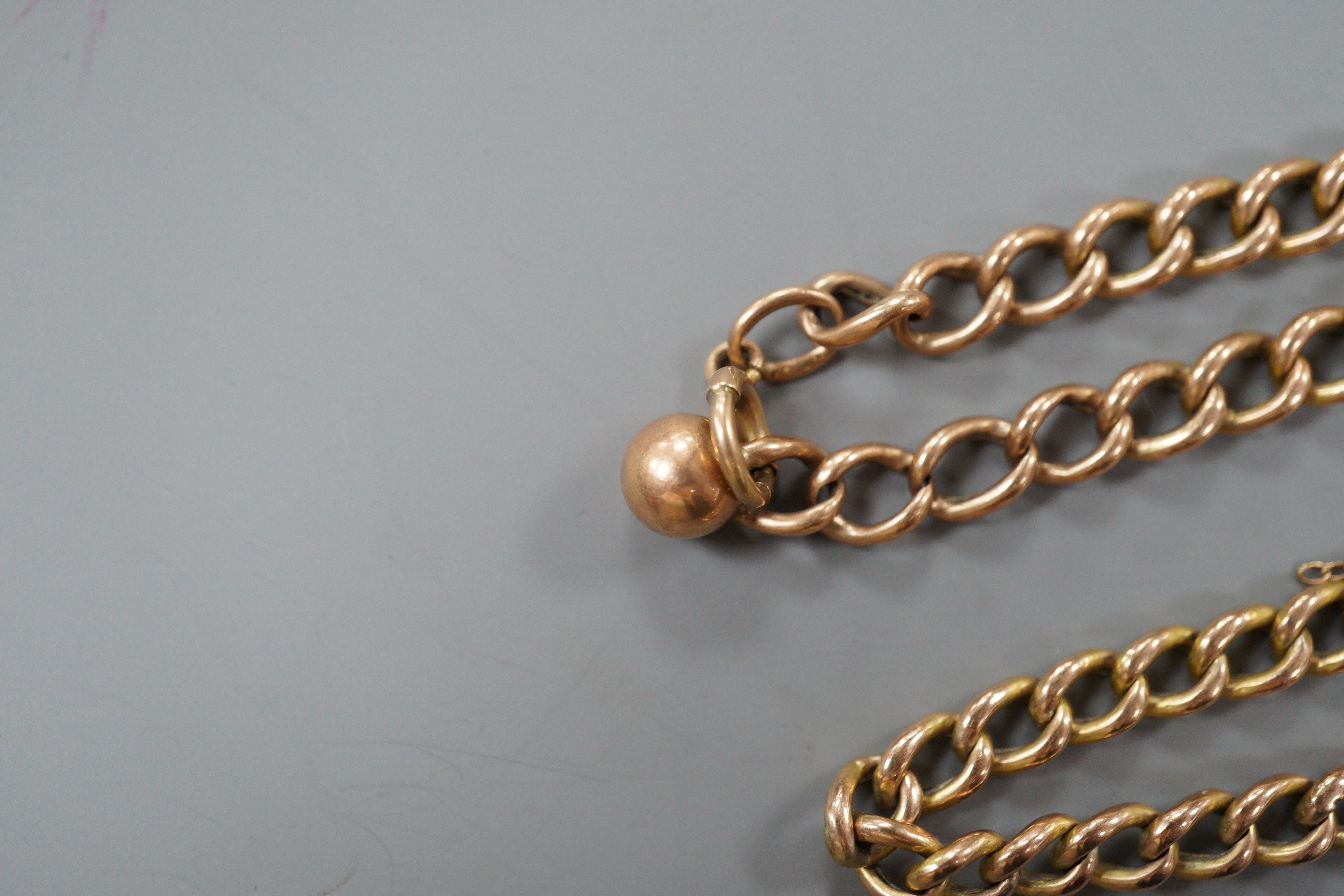 A 9ct curb link bracelet and a yellow metal curb link bracelet with 15ct clasp, gross weight 10.1 grams.